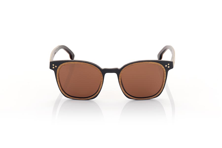 Wood eyewear of Walnut DAIVI. DAIVI wooden sunglasses are a variation of our GUSTAV model. In this model, the frame spectacularly combines walnut and oak wood in different reliefs, while the temples are made of oak on the outside and walnut on the inside. This unisex model combines the rounded relief with a squarer frame to give an elegant and sophisticated appearance. The glasses are available in two solid lens colors, brown and grey. With the DAIVI, you will have a fresh and modern look while enjoying the unique quality and style that only wooden glasses can offer. Front Measurement: 141X47mm Caliber:48 for Wholesale & Retail | Root Sunglasses® 